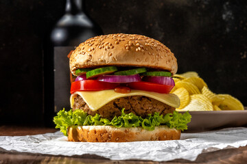 View of fresh tasty burger on wooden rustic table. Food background.