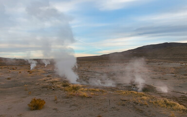 Geothermal Steam rising out of Cracks and Fissures in the desert floor of the Nevada desert near Reno at sunrise.