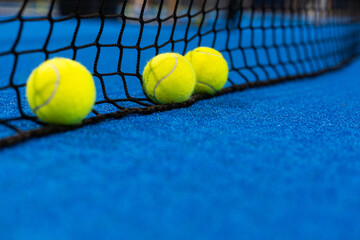 Three paddle tennis ball near the net, racket sports