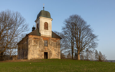 Naklejka premium historic country church on a meadow among trees