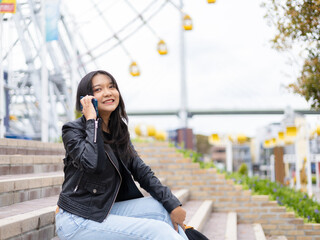 Travel lifestyle urban tourist, happy young girl using smartphone in Osaka Japan.