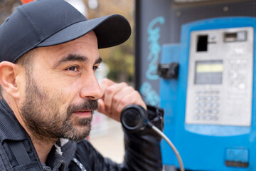man talking by  street phone