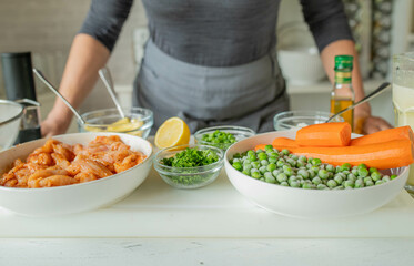 Woman with healthy ingredients on a cutting board for cooking a healthy dinner or lunch