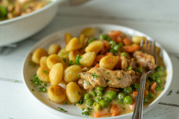 Creamy chicken with peas and carrots. Served with pan fried gnocchi