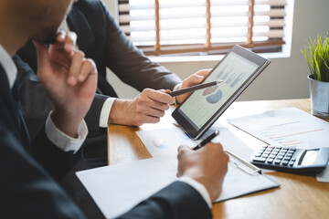financial advisory services. Asian advisor showing plan of investment to clients in the consultancy...
