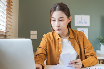 person using calculator calculating tax refund on the table