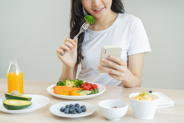 young female planning menu to eat ketogenic diet during weight loss program.