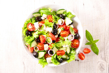 mixed vegetable salad with lettuce, tomatoes, cucumber and olives