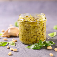 jar with homemade pesto sauce and ingredient