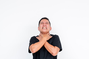 A frustrated middle-aged Asian man choking himself in exasperation, isolated on a white background.