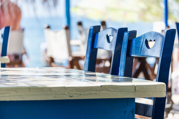 Beautiful wooden blue chairs in a beach restaurant