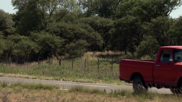 Old Red Pick Up Truck Driving on Rural Road in La Pampa Argentina