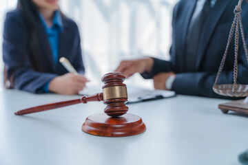 Lawyer engages with a smiling client during a legal consultation in a modern office.