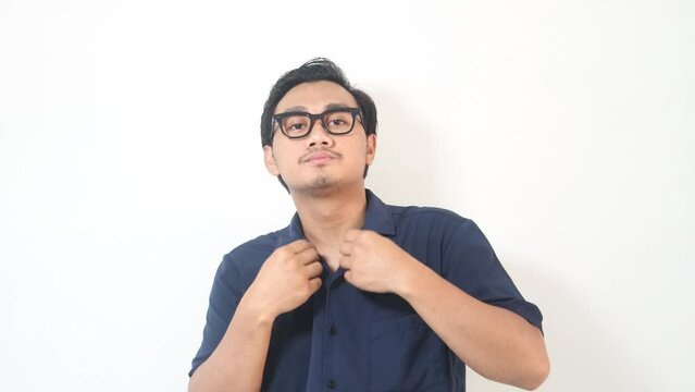 Asian man showing arrogant gesture while touching his shirt