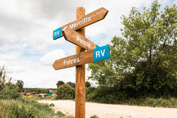 wooden pedestrian way marker showing directions to Marcilla, Peralta and Falces, province of Navarra, Spain