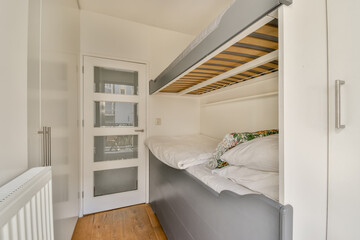 Space-saving bedroom design with elevated bed and wooden floor