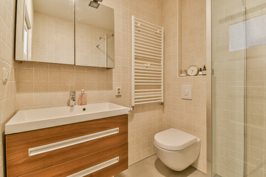 Modern beige bathroom with wooden vanity and shower