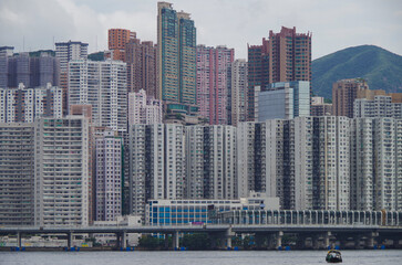 Fototapeta premium Panoramic skyline silhouette view of Hongkong Hong Kong Victoria Harbor and port infrastructure bay scenic landscape seascape scenery during twilight blue hour in China