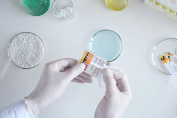 Top view a scientist in a chemical laboratory takes measurements of the acid-base balance of a...
