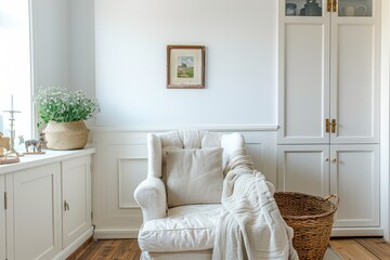  Living room interior, features an armchair and decorative accessories against a white wall. 