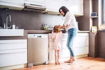 Grandma takes care of the grandchildren while parents are at work, spending time in kitchen,...