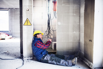 Electrocution hazard. Worker is injured on job site, electrical accident causing severe burns,...