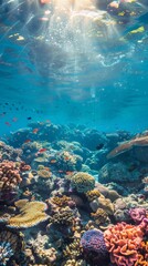 Obraz premium A vibrant coral reef teeming with colorful fish, sunlight dappling through the crystal-clear water