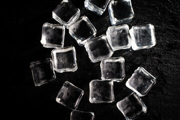 Ice cubes on a black background. Close-up, chosen focus