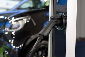 Close-up of a electric charging station on the background of electric car.