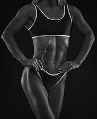 A slender swarthy Bodybuilder girl in red sportswear on a white background. Healthy lifestyle, sport and diet.