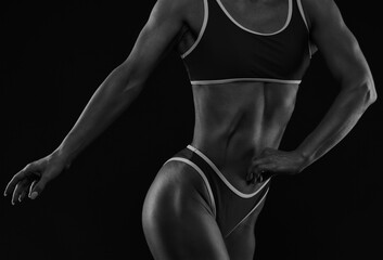 A slender swarthy Bodybuilder girl in red sportswear on a white background. Healthy lifestyle, sport and diet.