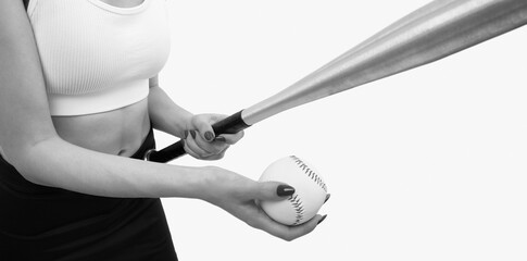 A young slender girl against a white background holds a bat and a baseball in her hands.