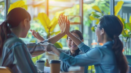 Smiling happy coworkers making hand high five also raising fist up of successful creative business project plan with highest profit value job in casual day at modern office at morning time
