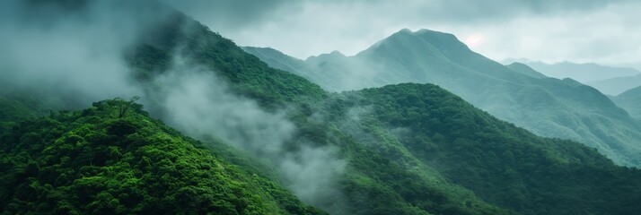 A captivating image of misty, lush green mountains under a moody sky, evoking a feeling of mystery...