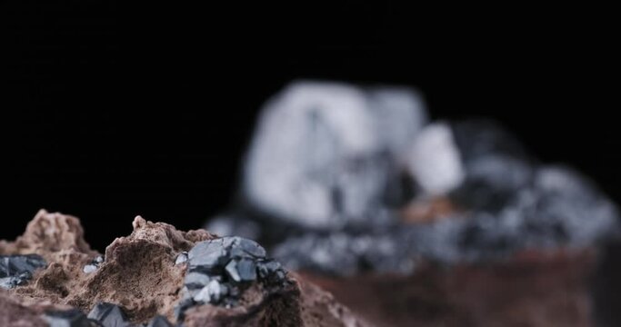 hematite crystals footage. From Wessels Mine, Kalahari Manganese, South Africa. on black background. macro detail close-up rough raw unpolished semi-precious gemstone.