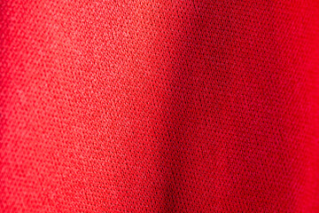 Red silk fabric close-up. Texture of red wavy fabric