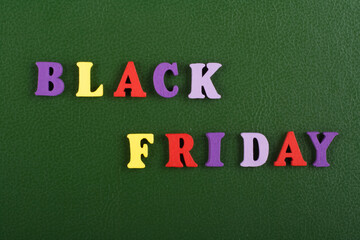 Obraz premium BLACK FRIDAY word on green background composed from colorful abc alphabet block wooden letters, copy space for ad text. Learning english concept.