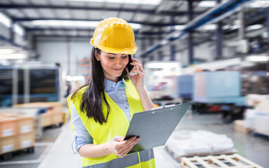 Manager woman in business casual clothes controlling goods in warehouse.