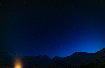 Night blue sky in spring evening with snow and star lights