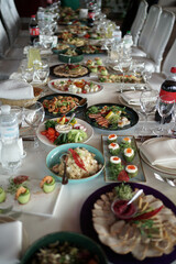 Festive table in the restaurant with dishes, drinks and snacks. Decoration of the festive table.