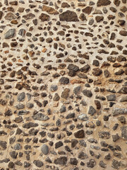 Irregular stone wall background. Architecture and construction. Decorative brick fence wall made of rock and cement.