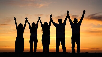 Teamwork people look at their future together at sunset, park. Unity of group of people united by...