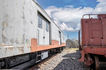 Obraz premium Two older railcars sitting at the end of a siding, daytime, sunny, nobody
