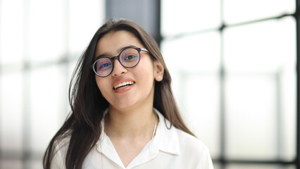 A close up head shot portrait of a preppy, young, beautiful, confident and attractive woman