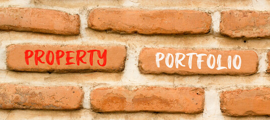Fototapeta premium Property portfolio symbol. Concept words Property portfolio on beautiful brick wall. Beautiful red brown brick wall background. Business Property portfolio concept. Copy space.