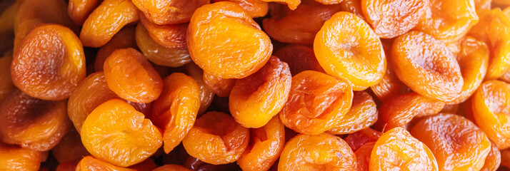 Orange dried apricots in close-up. Dried apricots on the counter at market. Dried fruits