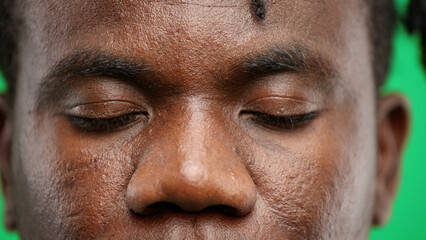 Fototapeta premium Man's eyes, close-up, on a green background