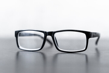 Fototapeta premium Close-up photo of sight eyeglasses is on the wooden table