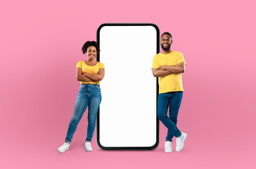 Black couple positioned in front of a blank screen on a mobile phone, possibly engaged in a video...