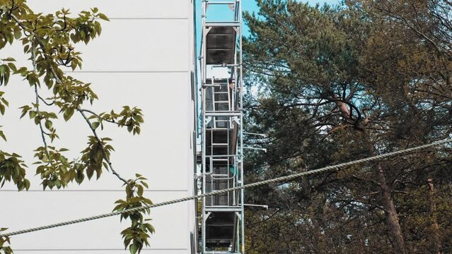 Metal Construction Site Scaffolding Used during Building Thermal Modernization for Compliance with European Green Deal Regulations